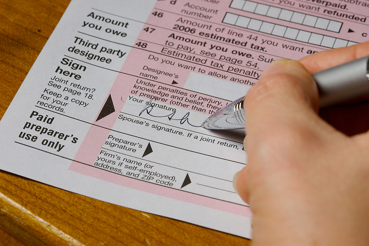 TaxPreparation picture of tax document being signed