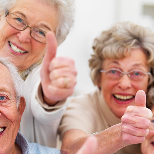 group of older adults with thumbs up