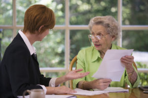 two women discussing financial paperwork