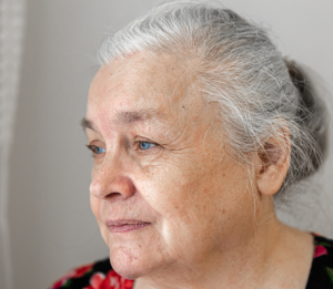 older woman looking out a window