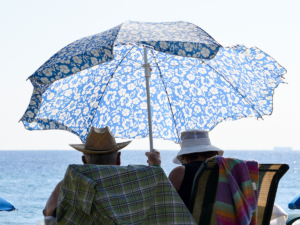picture of people under umbrella at the beach