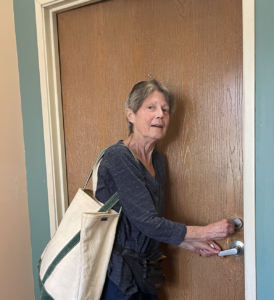 picture of Kathleen opening door to her new home