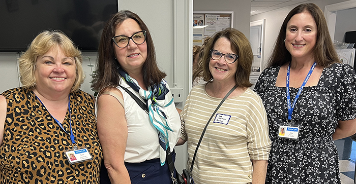 GardenCityTowersGrandOpening Four happy women at a corporate function